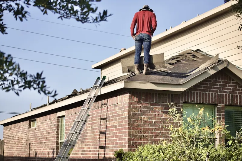 Professional roofer working on a residential roof in Center City